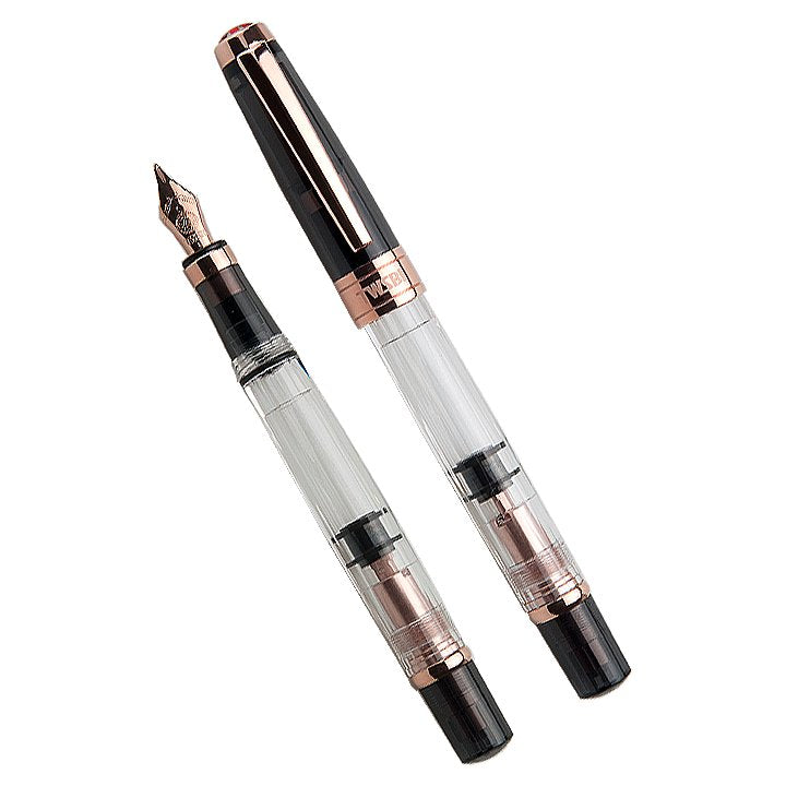 Two Diamond 580 (Smoke/Rose Gold) fountain pens, one capped and one uncapped, showcasing the clear barrel, rose-gold trim, and visible piston mechanism.
