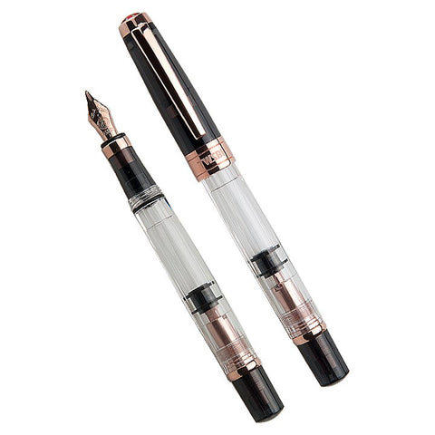 Diamond 580 (Smoke/Rose Gold) - Fine fountain pen, featuring a transparent barrel with visible piston mechanism, black screw-on cap, and rose-gold trim, shown capped and uncapped.