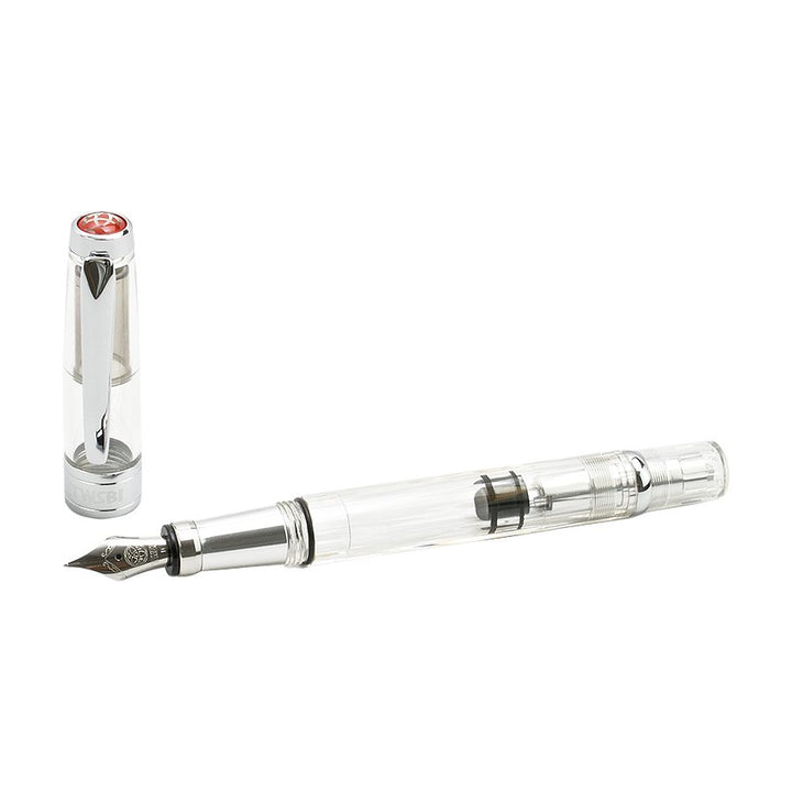 Diamond 580AL (Silver) - Medium fountain pen, uncapped, showcasing transparent barrel, steel nib, piston mechanism, and silver trim, with a clear cap featuring a metal clip.