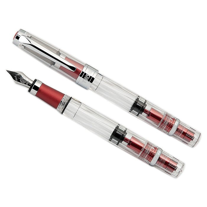 Diamond 580AL (Rose Red) - Broad fountain pen with clear barrel, red metal accents, stainless-steel nib, and visible piston-filling mechanism, shown capped and uncapped.