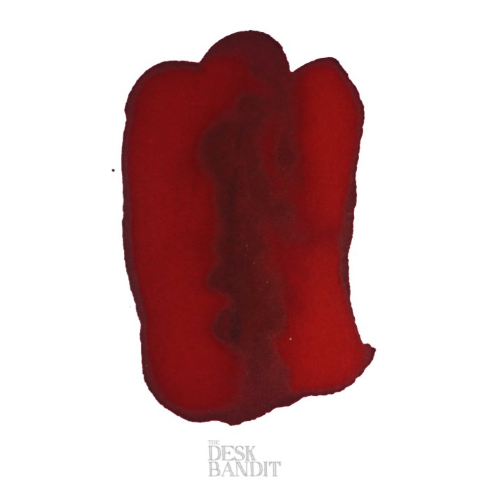 Direct Sun - 2ml ink sample by Robert Oster, featuring an abstract red swatch with tonal variations on white paper, with THE DESK BANDIT watermark.