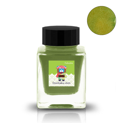 Dontaku-min (Fukuoka Special) - 30ml green ink in a square glass bottle with black cap, colorful label featuring a festival mascot, includes a circular ink swatch.