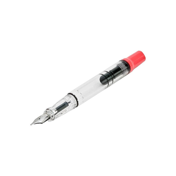 ECO-T (Coral) - Fine fountain pen with a clear barrel, showcasing a piston fill mechanism, metal nib, and red end cap.