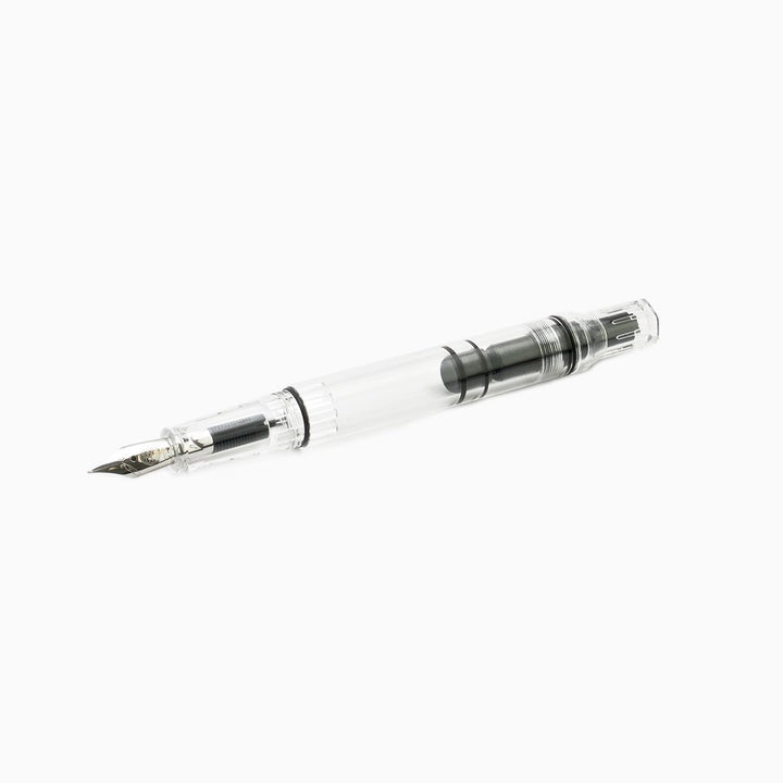 ECO-T (Clear) - Broad fountain pen displaying a clear barrel with visible piston-filling mechanism and a metal nib, designed for improved grip technique.