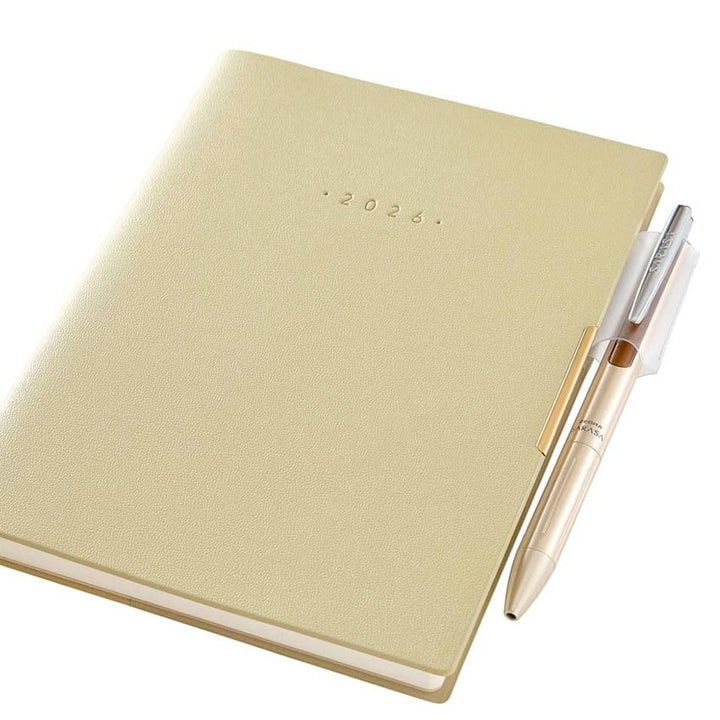 2026 Ecri Plus 7 Weekly Planner - B6 in pale-yellow with embossed “2026” and a matching pen clipped to the side, showcasing NOLTY's Japanese craftsmanship.