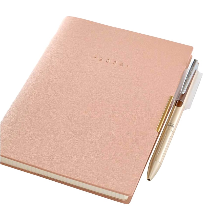 2026 Ecri Plus Memo - B6 (Pink) planner with gold pen, featuring monthly and weekly spreads, grid note pages, and protective cover, crafted by NOLTY in Japan.