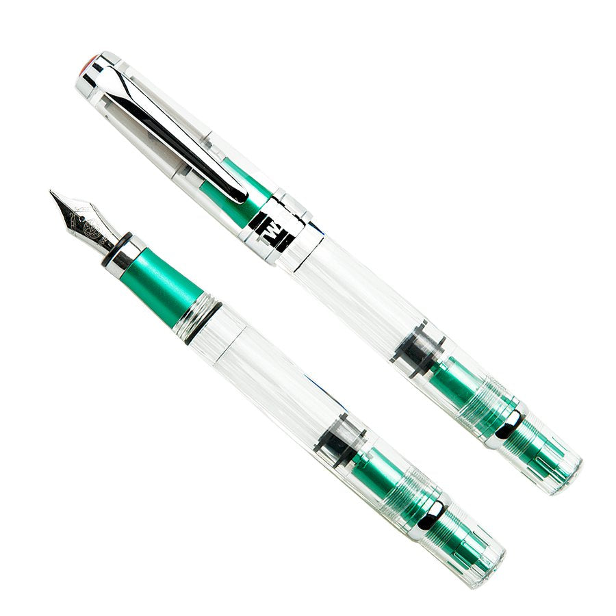 Diamond 580AL (Emerald Green) - Fine fountain pen features a transparent body, green metal trim, steel nib, and piston-fill mechanism, shown capped and uncapped.