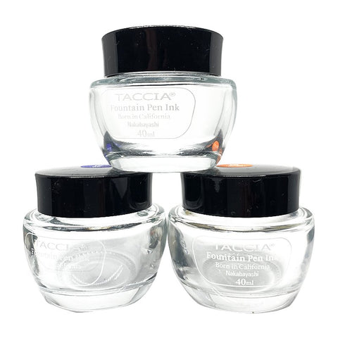 Taccia Empty Bottle (ANY Bottle): Three clear glass jars, 40ml each, with black lids, labeled for ink. Perfect for reuse, supporting charity through purchase.