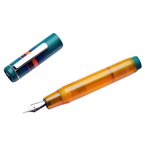 Fantasia - Green (Broad) fountain pen disassembled, showing translucent orange barrel with exposed nib, teal cap with metal clip, and decorative stripes.