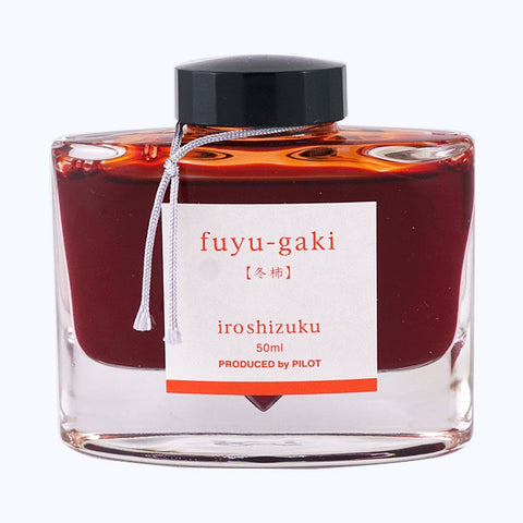 Iroshizuku Ink - Fuyu Gaki (50ml) in a sleek glass bottle, showcasing Pilot's signature design for their vivid persimmon-orange fountain-pen ink.