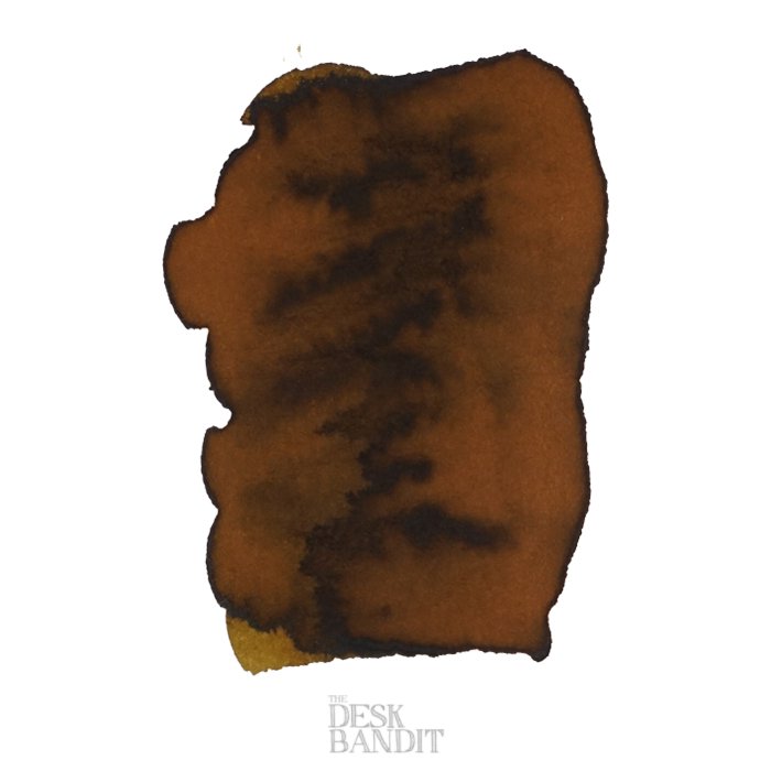Gold Antiqua - 50ml ink swatch showing warm brown with darker edges on white paper, featuring THE DESK BANDIT watermark, capturing Robert Oster&