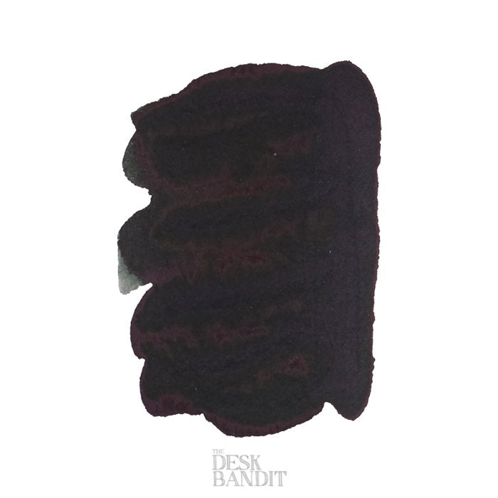 Graphite - 50ml ink swatch, showing a dark, layered purple-black patch on white, with The Desk Bandit watermark, representing Robert Oster's dye-based fountain pen ink.