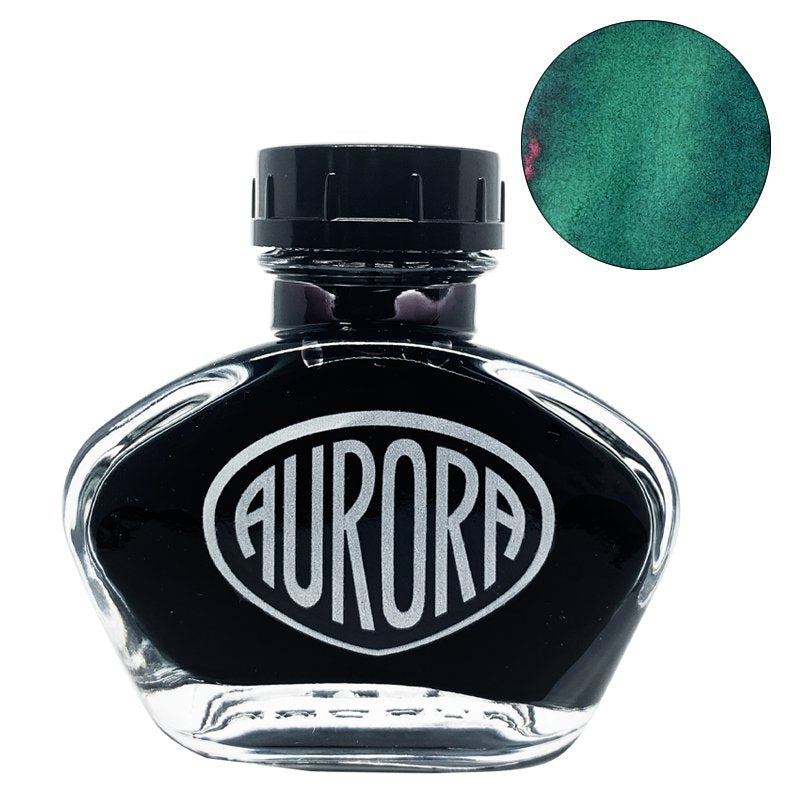 Aurora 100th Anniversary - Green (2ml) fountain-pen ink in a glass bottle, featuring the AURORA logo, with a teal-green ink swatch beside it.