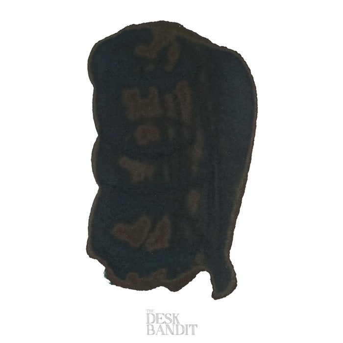 Green At Night - 50ml dye-based ink by Robert Oster, featuring an irregular dark-brown/black organic-shaped object, branded as THE DESK BANDIT against a white background.