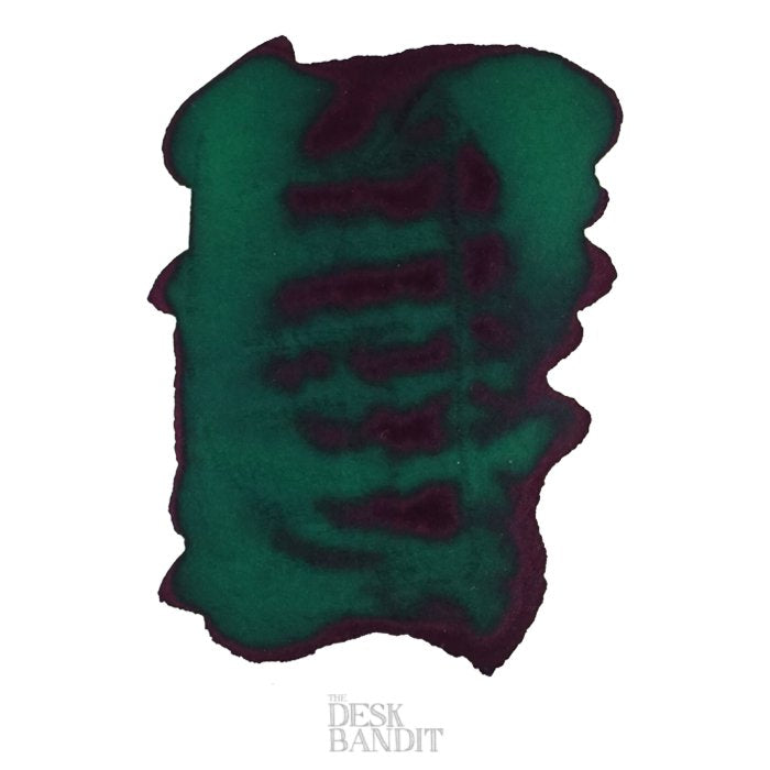 Green Diamond - 2ml ink sample showing teal-green swatch with purplish sheen and darker striations, featuring THE DESK BANDIT watermark.