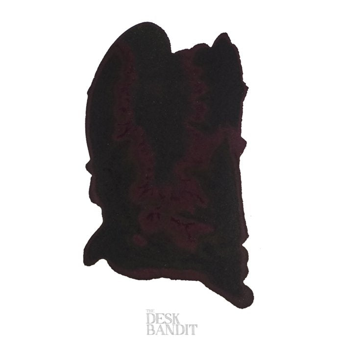 Swatch of Robert Oster Grun Schwarz ink, nearly black with burgundy hint, on white paper with THE DESK BANDIT watermark, reflecting Australian palette inspiration.