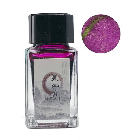 Moon Over A Mountain - 18ml bottle of shimmering magenta ink with gold-green sparkles, featuring a square glass base and black cap. Close-up shows ink's glittery particles.