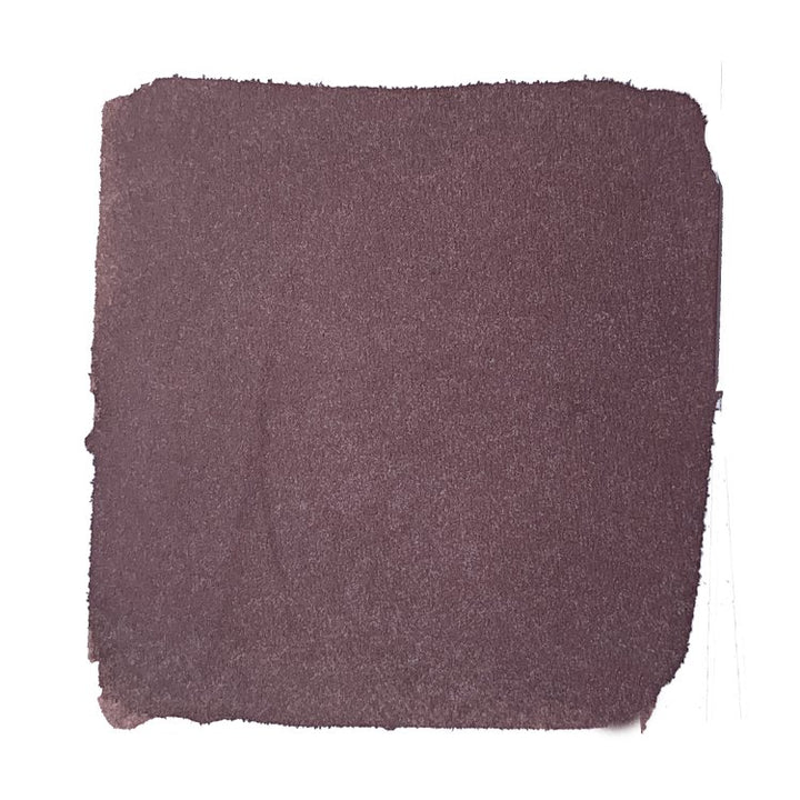 House Divided - 2ml ink bottle shown with a coarse, brownish-purple sandpaper sheet, highlighting its unique dye-based, partially bulletproof, and waterproof characteristics.