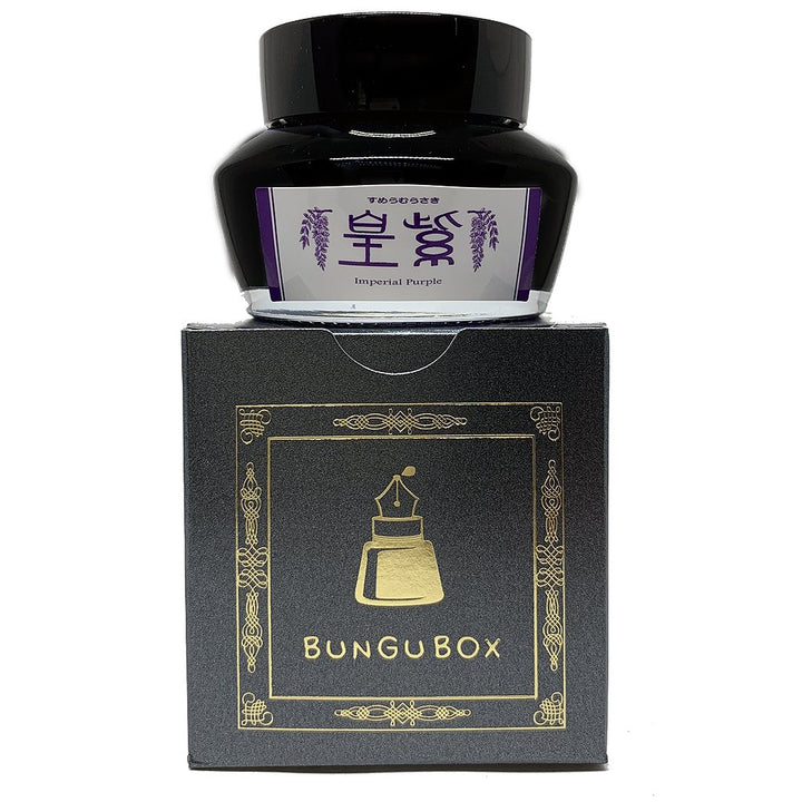 Bungubox Imperial Purple - 2ml fountain pen ink bottle atop its elegant black-and-gold box, showcasing the brand's dedication to writing pleasures.