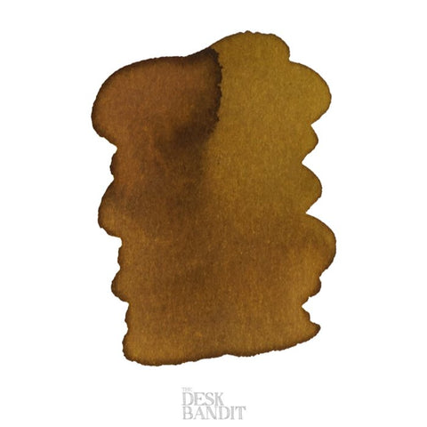Iroshizuku Ink - Ina-ho (2ml) swatch showcasing an abstract ink wash, transitioning from deep brown to mustard-yellow, with THE DESK BANDIT watermark visible.