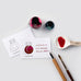 Ink Swatch Cards - Size B (Swatch) by Colorverse, featuring fountain pen ink and drawing tools, including cards, glass bottles, porcelain spoon, dip pen, and paintbrush.