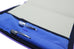Seed A5 - Iris / Electric Blue organizer open to show two metal pens in loops and a blank notepad, showcasing Nock Co.'s refined design.