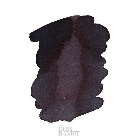 Iroshizuku Ink - Kiri-Same (2ml), a dark ink with a subtle purple hue, shown as a blot on paper with The Desk Bandit watermark.