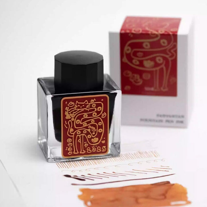Kitty Snake - 50ml fountain pen ink by Fanyantan, with a unique cat motif label, shown with swatches, displaying its vibrant brownish-orange hue.