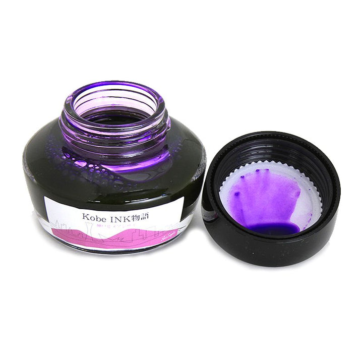 No.57 Kobe Hydrangea - 50ml fountain-pen ink in a squat glass bottle, cap removed. Vivid purple ink smudges visible on the cap&
