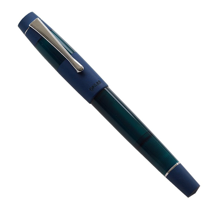 OPUS 88 Koloro (Blue) - Medium fountain pen with translucent dark-green barrel, matte navy-blue cap, chrome trim, showcasing elegant design and #5 branded German nib.