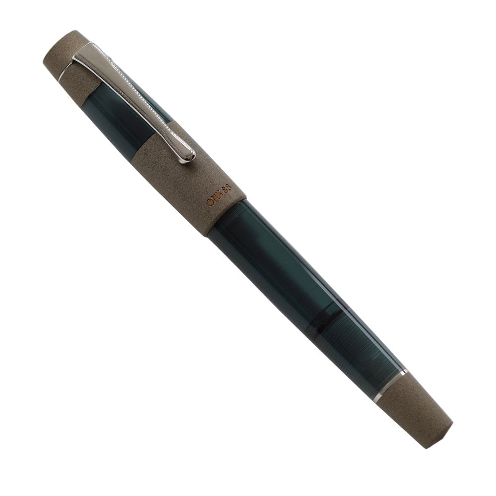 OPUS 88 Koloro (Teal) - Medium fountain pen with translucent green body, textured sand-colored cap, chrome-plated clip, showcasing a semi-transparent design for visible ink flow.