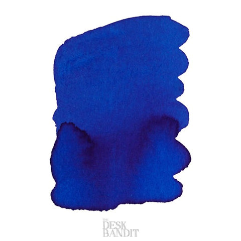 Iroshizuku Ink - Kon-Peki (2ml) swatch shows deep blue pigment with textured shading on white, labeled “THE DESK BANDIT” at the bottom.