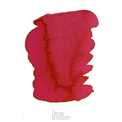 Iroshizuku Ink - Kosumosu (2ml) sample, featuring a red-pink ink blot on white, with The Desk Bandit watermark, inspired by cherry blossoms in fall.
