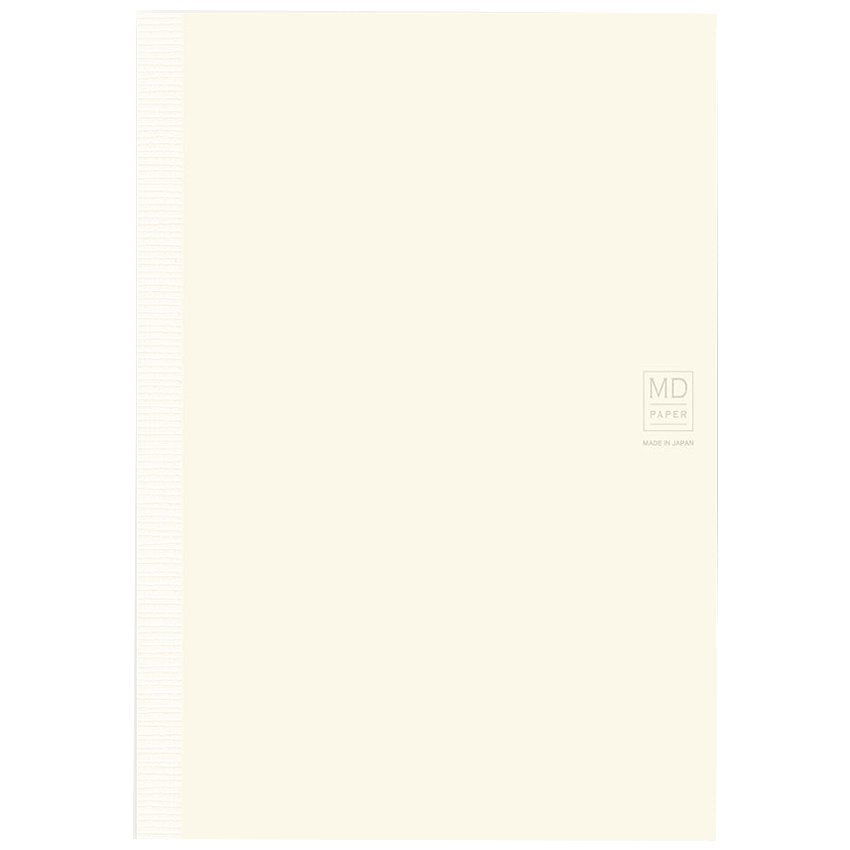 Midori MD Notebook A5 Lined with cream-colored cover, visible binding strip, and “MD PAPER – MADE IN JAPAN” logo on the lower right corner.
