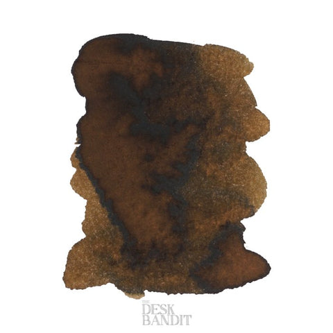 Abstract ink swatch of Robert Oster's Melon Tea - 2ml, showing a brown-black stain with feathering on white, featuring The Desk Bandit watermark.