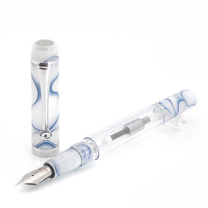 Planet Series (Mercury) - Fine: A clear-barrel fountain pen with visible piston mechanism, steel nib, and marbled white-and-blue cap with metal clip, shown uncapped.