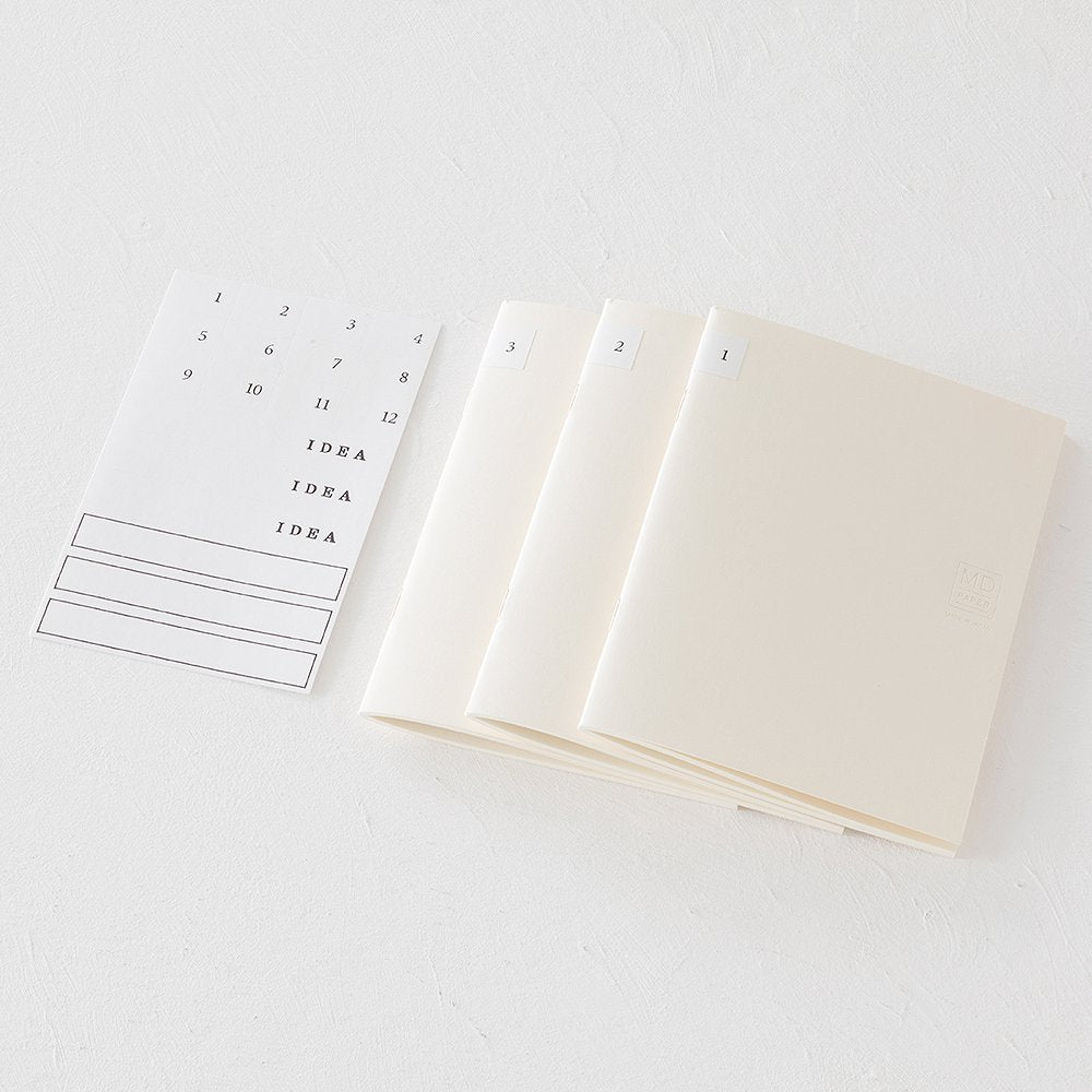 MD Notebook Lite - A5 Lined/Ruled (3 pack) with tabbed cream booklets and a sticker sheet for organization, ideal for capturing ideas anytime.