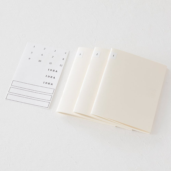 MD Notebook Lite - A5 Lined/Ruled (3 pack) with tabbed cream booklets and a sticker sheet for organization, ideal for capturing ideas anytime.