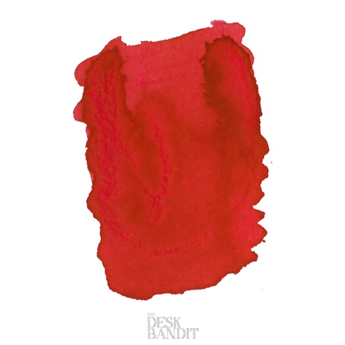 Swatch of Iroshizuku Ink - Momiji (2ml) showing organic edges and tonal variations, with “The Desk Bandit” faintly marked, depicting its vibrant, autumn-inspired hue.