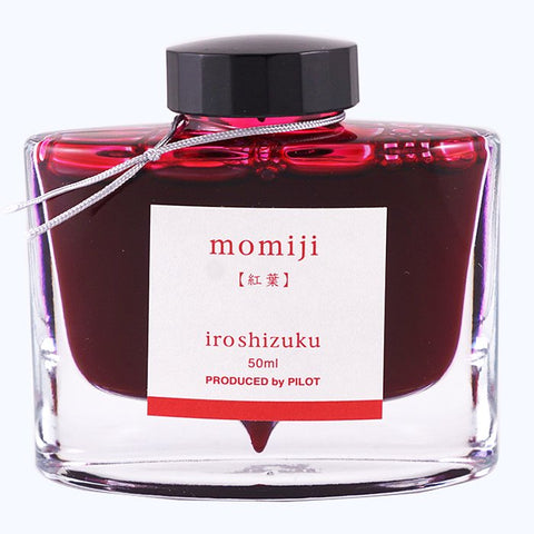 Iroshizuku Ink - Momiji (50ml): A clear, flat-sided glass bottle with black cap, silver cord, and label, showcasing Pilot's deep pink fountain-pen ink.