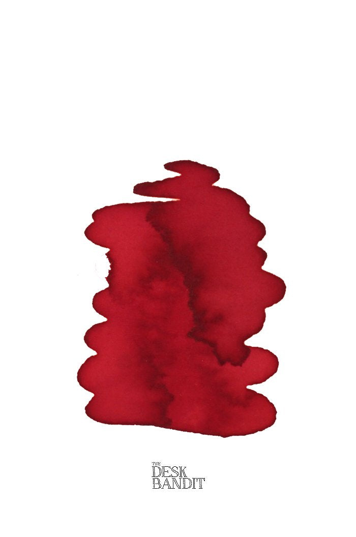 Swatch of Rohrer & Klingner Morinda ink, a deep red dye-based product, with THE DESK BANDIT logo, showcasing a 2ml sample for fountain pens or painting.