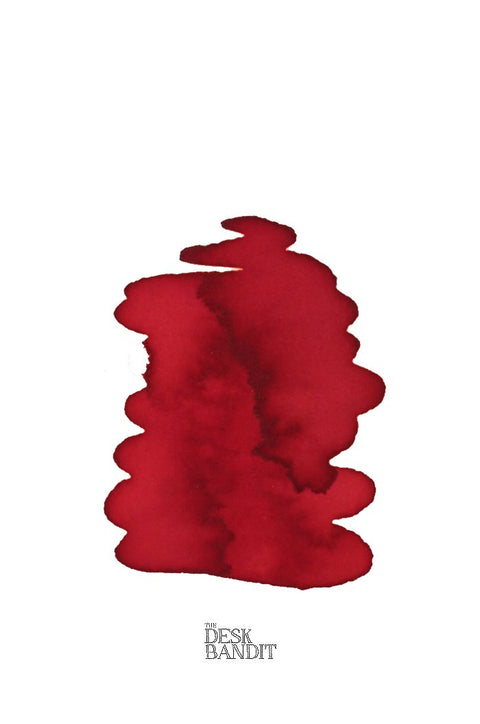 Swatch of Rohrer & Klingner Morinda ink, a deep red dye-based product, with THE DESK BANDIT logo, showcasing a 2ml sample for fountain pens or painting.