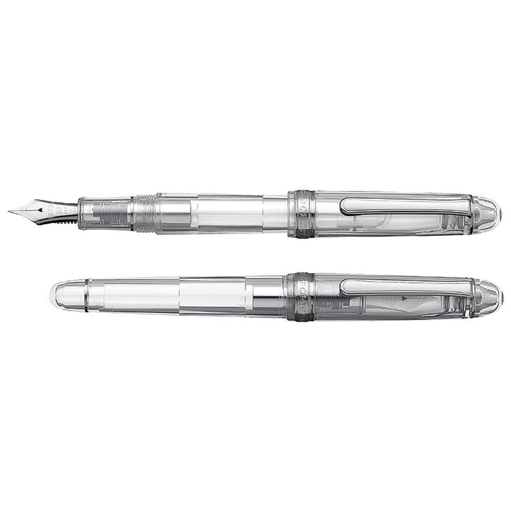 The #3776 Century Oshino - Fine features a transparent design with a visible piston-filling mechanism, chrome accents, and an uncapped steel nib.