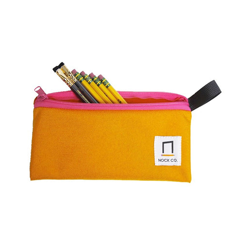 Pencil Pouch - Saffron by Nock Co., partially unzipped, displays yellow pencils and writing tools, featuring an orange body, pink zipper, and black loop.