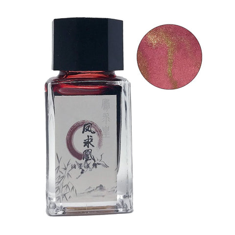 Phoenix - 18ml: Rectangular glass bottle of red shimmer fountain-pen ink with black cap, decorative label, and close-up of pink-red ink flecked with gold.
