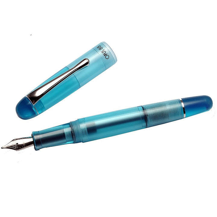 Translucent turquoise OPUS 88 Picnic - Blue (Fine) fountain pen with silver nib and cap, showcasing its semi-transparent design for visible ink.