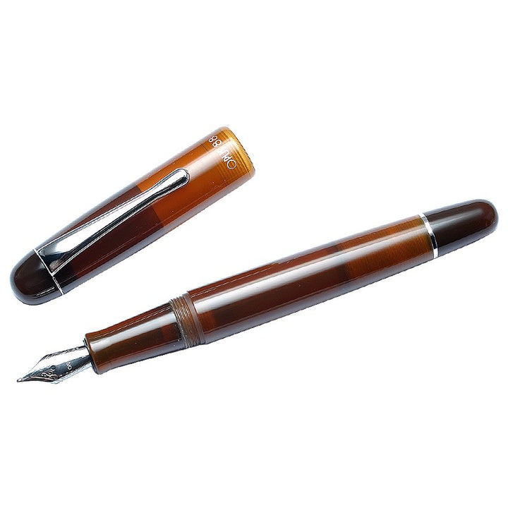 OPUS 88 Picnic - Brown (Fine) fountain pen with cap off, displaying steel nib and semi-transparent barrel, showcasing ink visibility and unique eyedropper filling mechanism.