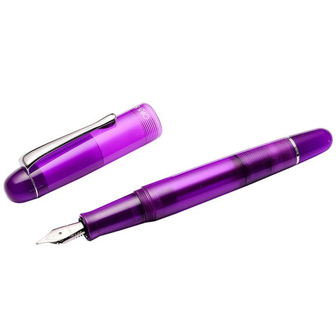 Translucent purple OPUS 88 Picnic fountain pen, cap removed, revealing silver nib. Ebonite and resin body showcases ink. Includes eyedropper tool. Fine #5 JoWo nib.