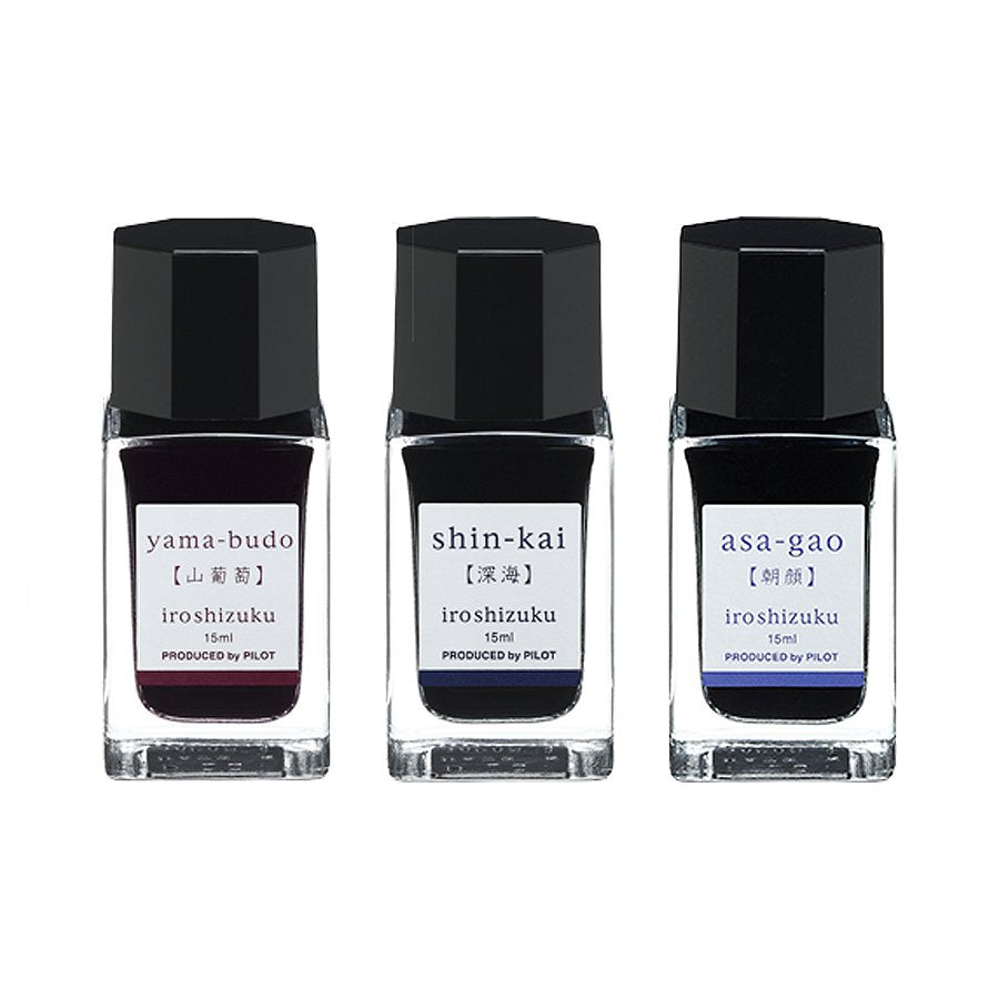 Iroshizuku Mini Ink Set B featuring three 15 ml glass bottles with faceted black caps: yama-budō, shin-kai, and asa-gāo, displayed in a Pilot gift box.