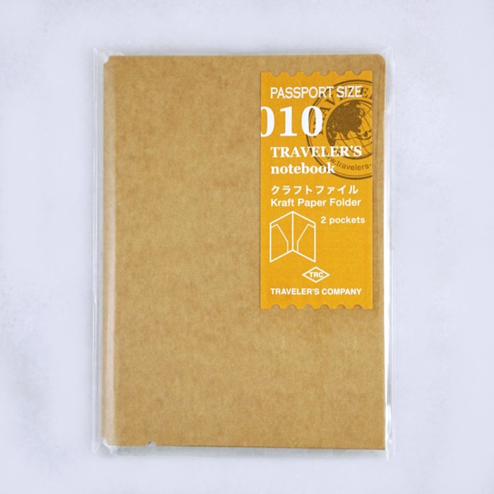 Traveler’s Notebook 010 Kraft Folder (Passport) in clear plastic wrapper, featuring two internal pockets, ideal for storing notes or travel tickets.